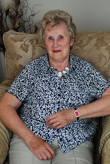 Joan, Lifeline alarm user, wearing her MyAmie pendant on her wrist