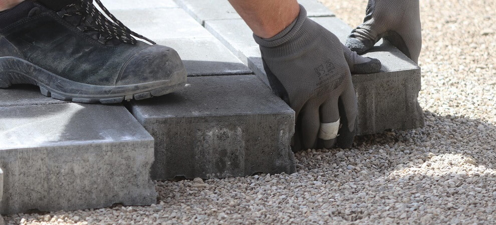 paving slabs being installed in a small garden